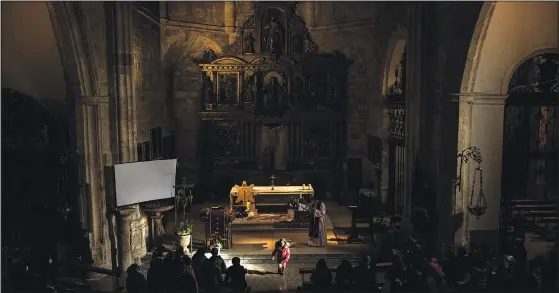  ?? ?? A girl walks through a beam of light Nov. 27 in the church of Morales del Vino during the celebratio­n of a special catechesis for both children and parents in Morales del Vino in Zamora province.