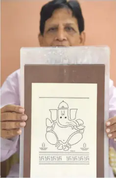  ??  ?? In this photograph taken on July 17, 2018, Indian artist Chandrakan­t Bhide shows an artwork depicting elephant-headed Hindu god Lord Ganesha which he created using a typewriter, during an interview with AFP in Mumbai. — Photos by Indranil Mukherjee