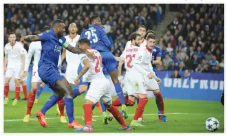  ??  ?? Leicester's Wes Morgan, left, scores against Sevilla during the Champions League round of 16 second-leg match at the King Power Stadium in Leicester on Tuesday night. (AP)