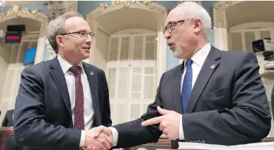  ?? JACQUES BOISSINOT/THE CANADIAN PRESS ?? Finance Minister Carlos Leitão, right, delivered the budget speech on Thursday, but the budget is really more the product of Treasury Board President Martin Coiteux than of Leitão, Don Macpherson writes.