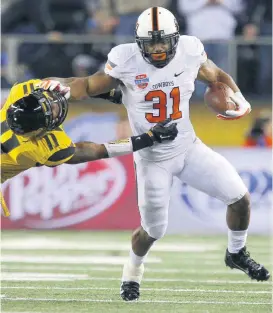  ?? [OKLAHOMAN ARCHIVES] ?? Oklahoma State’s Jeremy Smith, right, fights off Missouri’s Aarion Penton during the 2014 Cotton Bowl, the last time the Cowboys faced the Tigers before their upcoming meeting in the 2018 Liberty Bowl.