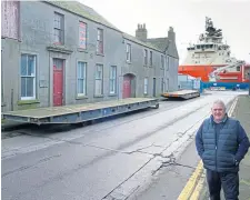  ??  ?? Councillor Stewart beside the trailers.