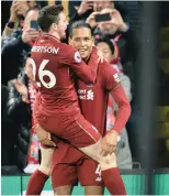  ?? EPA ?? LIVERPOOL’S Virgil van Dijk celebrates a goal with teammate Andy Robertson. |