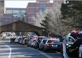  ?? THE ASSOCIATED PRESS ?? Police officers line up their patrol cars outside of Littleton Adventist Hospital for a procession honoring an officer who was fatally wounded in a domestic incident in a Highlands Ranch apartment complex on Sunday. Multiple other police officers and...