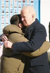  ?? UKRAINIAN PRESIDENTI­AL PRESS OFFICE VIA AP ?? President Joe Biden, right, and Ukrainian President Volodymyr Zelenskyy hug as they say goodbye Monday at the Memorial Wall of Fallen Defenders of Ukraine in Russian-Ukrainian War, in Kyiv.