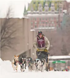  ?? JACQUES BOISSINOT/ THE CANADIAN PRESS ?? A musher races his six-dog sled during the winter carnival in 2012. Other events include axe-throwing and ice-canoe racing.