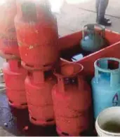  ??  ?? The 14kg and 50kg LPG gas barrels found at the store during a raid in Subang Jaya yesterday.