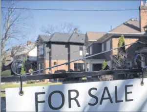  ?? CP PHOTO ?? A sold sign is shown in front of west-end Toronto homes in 2017. The Toronto Real Estate Board says home sales in the Greater Toronto Area in March fell 39.5 per cent compared with a year ago.