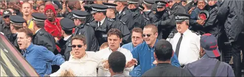  ??  ?? The accused, left to right: David Norris, Jamie Acourt, Neil Acourt, obscured, Luke Knight and Gary Dobson, wearing dark glasses, leave the Stephen Lawrence inquiry on June 30, 1998. Norris and Dobson were eventually convicted of racist killing