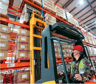  ??  ?? A forklift worker is preparing goods to be exported to Europe at the Chengdu Railway Bonded Center on February 27, 2020.