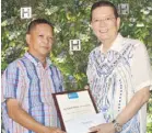  ??  ?? Henann Group of Resorts chairman Dr. Henry Chusuey (right) with 20-year service awardee Mandolino Montuya.