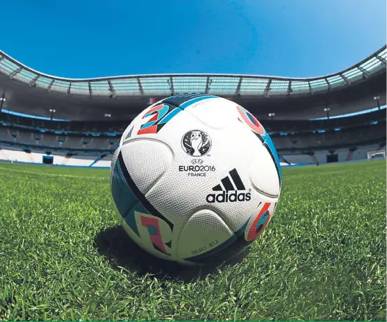  ??  ?? Above: A match ball sits on the turf at Stade de France in Paris, which will host the opening match of the Uefa Euro 2016 between France and Romania tonight; opposite page: Roy Hodgson keeps a close eye on England training, Northern Ireland boss...