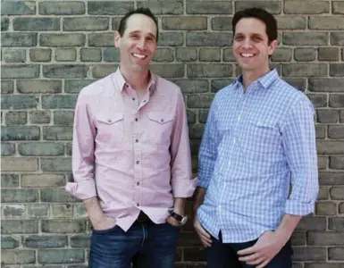  ?? ANDREW FRANCIS WALLACE/TORONTO STAR ?? The Balfour Building’s accessible downtown location and historic architectu­re is among one of the city’s old buildings that offer appealing workspaces for start-up companies such as Askuity, headed by CEO Eric Green, left, and COO Neal Sherman.