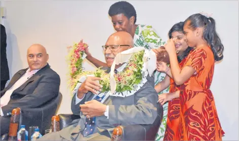  ?? Picture: ELIKI NUKUTABU ?? PM Sitiveni Rabuka is garlanded at Ajay Bhai Amrit’s book launch in Suva.