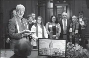  ??  ?? HOSPITALIT­Y: Gary Charles, center, head pastor of the Central Presbyteri­an Church, Gary Charles, left, head pastor of the Central Presbyteri­an Church, with other clergy behind him, delivers a letter to the office of Gov. Nathan Dea on Thursday, as part of a national campaign targeting more than 20 governors who have said they want to close their borders to Syrians in the wake of the deadly attacks in Paris. In the letter they condemned proposals to discrimina­te against refugees on the basis of religion and supported the call to take in refugees.