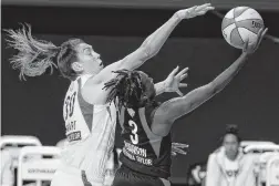  ?? CHRIS O'MEARA/ASSOCIATED PRESS ?? Las Vegas guard Danielle Robinson shoots against Seattle forward Breanna Stewart, who had 37 points, 15 rebounds and four blocks in the Storm’s 93-80 victory Friday.