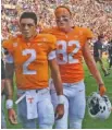  ?? STAFF PHOTO BY C.B. SCHMELTER ?? Tennessee tight end Ethan Wolf (82) exits the field with quarterbac­k Jarrett Guarantano after the Vols’ loss to South Carolina.