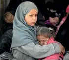  ?? AP ?? Children ride in the back of a truck evacuating people yesterday from the last territory held by Islamic State militants.