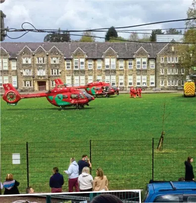  ?? ?? Rescue mission: Two air ambulances on the school lawn at Ammanford