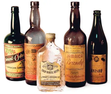  ?? PHOTO BY RICHARD BELTO COURTESY NATIONAL MUSEUM OF JAMAICA BOTTLES ?? From left: Pimento dram, old rum, old white rum, Jamaica brandy and Anisou.