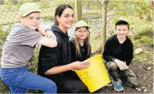  ??  ?? Animal keeper Laura Greger with the youngsters after they helped feed monkeys