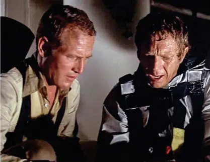  ?? ?? Competitiv­e: Paul Newman, left, and Steve McQueen in the 1974 movie The Towering Inferno