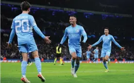  ?? Photograph: Matt McNulty/Manchester City FC/
Getty Images ?? Gabriel Jesus runs to celebrate of Manchester City’s winner against PSG with Bernardo Silva as João Cancelo looks to join the fun.