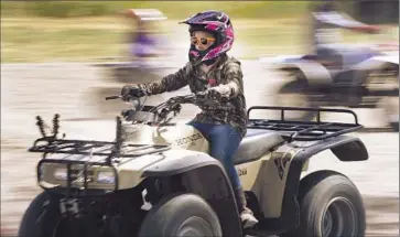  ?? Scott Sommerdorf
Salt L ake Tribune ?? A YOUTH rides an all-terrain vehicle in Ogden, where unemployme­nt rates hover around 3.5% versus 5.3% nationally. Residents are more likely to own a home, afford college, avoid debt and have health coverage.