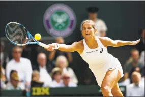  ?? Julian Finney / Getty Images ?? Julia Goerges returns a shot against Serena Williams during the Wimbledon semis.