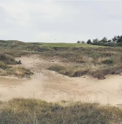  ?? ?? ↑ A bunker on the spectacula­r new short hole on the back nine at Royal Liverpool, designed by Martin Ebert