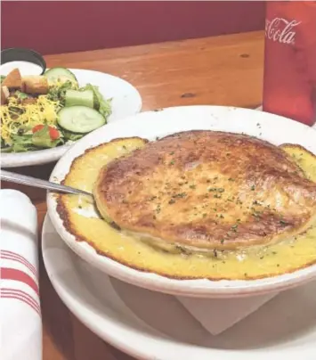  ?? PHOTO BY SUSAN PIERCE ?? Order one of Bones Smokehouse’s chicken potpies and two salads and you’ve got dinner for two. The 6-inch potpie can easily serve two people.