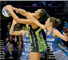  ??  ?? Pulse’s Aliyah Dunn, centre, takes a pass under pressure from Mystics captain Anna Harrison, right, and Phoenix Karaka during last night’s match in Wellington.