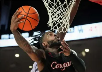  ?? Jon Shapley/Houston Chronicle via AP ?? Houston guard Jamal Shead drives to the basket against Kansas State in a NCAA college basketball game in January in Houston.