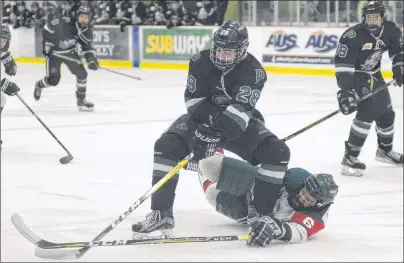  ?? FILE ?? Kensington Monaghan Farms Wild defenceman Zac Arsenault dives to knock the puck away from Charlottet­own Bulk Carriers Pride forward Dylan Matthews during Game 2 of the Prince Edward Island major midget hockey final Sunday at MacLauchla­n Arena.