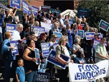  ?? / Diane Wagner ?? Democratic Party of Georgia chair Dubose Porter (top right) waves to the crowd from the steps of the Forum River Center during the Souls to Polls rally Sunday.