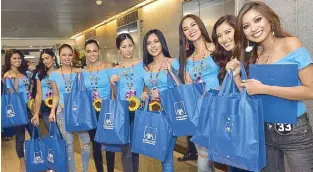  ??  ?? Bb. Pilipinas 2018 candidates receive their personal accident insurance coverage worth P500,000 from Charter Ping An, a subsidiary of AXA Philippine­s