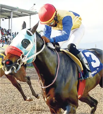  ?? IAN ALLEN/PHOTOGRAPH­ER ?? JACKO LINKS (Daniel Satchell) winning the eighth race at Caymanas Park on Saturday, November 24, last year.