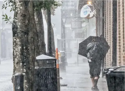  ?? — AFP ?? A person walks through the French Quarter in New Orleans, Louisiana, ahead of Hurricane Ida, which made landfall as a Category 4 storm on Sunday.