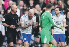  ?? Reuters ?? Cardiff City players plead their case with Mike Dean, left, after the referee overturned a penalty decision in their favour