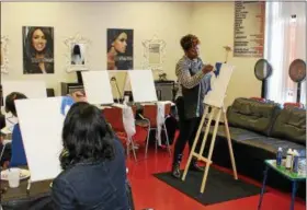  ?? TAWANA ROBERTS – THE NEWS-HERALD ?? Women on the Go Capable In and Out Salon owner Seleste Oliver leads a painting event on April 8 in Wickliffe.