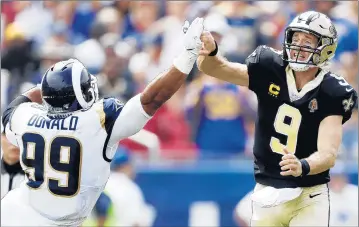  ?? SEAN M. HAFFEY/GETTY ?? Saints QB Drew Brees injures his right thumb Sunday after it hit the hand of Rams All-Pro DT Aaron Donald.