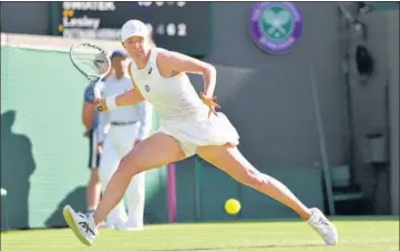  ?? AP ?? Poland's Iga Swiatek returns against Lesley Pattinama Kerkhove of the Netherland­s at Wimbledon on Thursday.