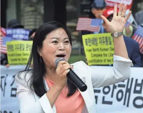  ?? CHUNG SUNG JUN/GETTY IMAGES ?? A defector takes part in an anti-North Korea rally in September in Seoul. About 70% of North Korean defectors are women.