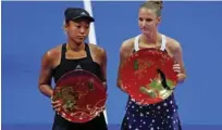  ?? – Reuters ?? THANK YOU: Karolina Pliskova, right, and Naomi Osaka pose with their trophies.