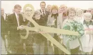  ?? Photo by Chris Rush ?? This photo, originally published Dec. 2, 1998, shows then Benton County Judge Clyde Cummings, left, and Bella Vista Justice of the Peace Shirley Borhauer cutting the ribbon at the new Sugar Creek Bridge on what was then Dartmoor Road.