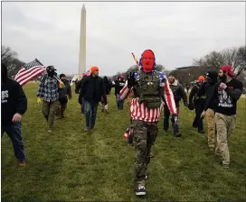  ?? CAROLYN KASTER — THE ASSOCIATED PRESS ?? People march with those who claim they are members of the Proud Boys as they attend a rally in Washington, Wednesday, Jan. 6, 2021, in support of President Donald Trump.