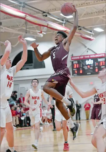  ?? TIM MARTIN/THE DAY ?? East Lyme’s Dev Ostrowski (5) rises over NFA’s Aidan Miller (14) and Nik Hay, right, for two points during a game in Norwich on Feb. 13. The top-seeded Vikings play No. 2 Waterford for the Eastern Connecticu­t Conference Division I tournament...