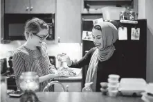  ?? Marie D. De Jesús / Houston Chronicle ?? Noha Sahnoune, right, breaks fast with her friend Emma Armer during the holy month of Ramadan.