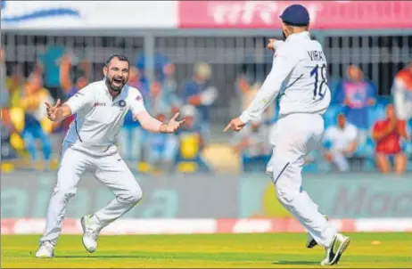  ?? AFP ?? Mohammed Shami (left) celebrates with India captain Virat Kohli after dismissing Bangladesh's Mushfiqur Rahim on the first day of the first Test, in Indore on Thursday.