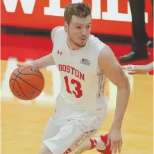  ?? STAFF PHOTOS BY NICOLAUS CZARNECKI ?? TOP TERRIERS: Will Goff controls the ball during Boston University’s 92-81 victory against Lehigh last night at Case Gym; at right, Walter Whyte goes in for a layup as part of his double-double performanc­e.